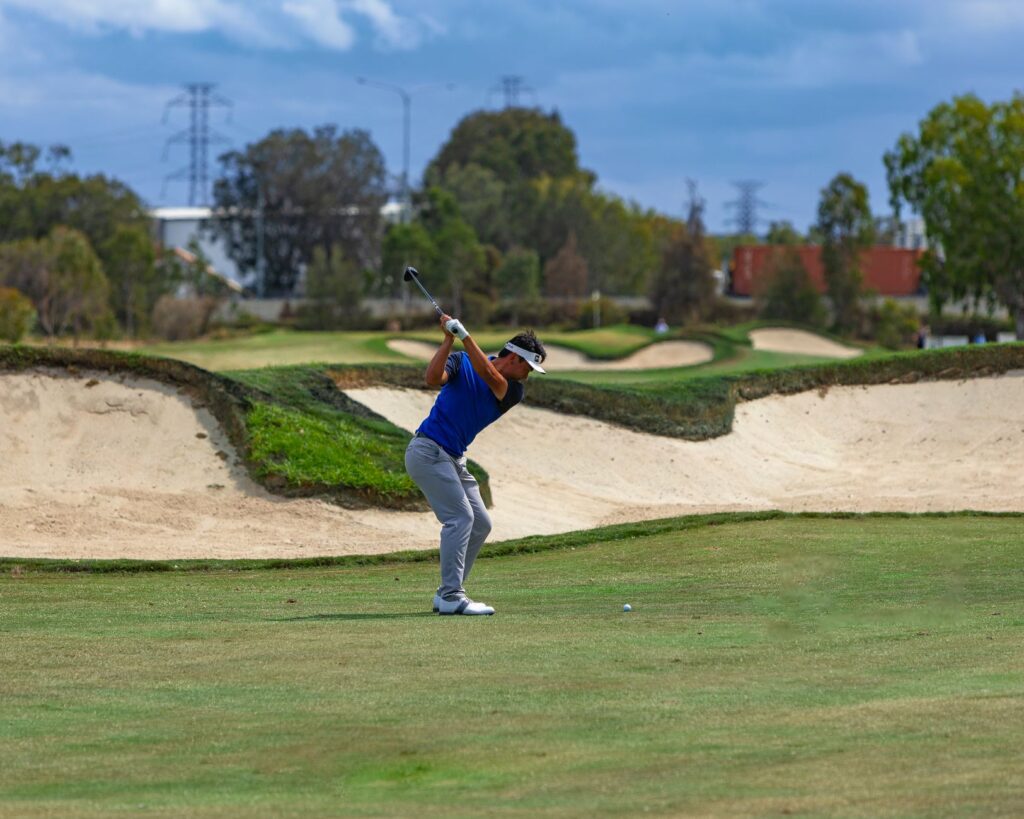 Photograph of a golfer performing a follow-through correctly — golf swing errors