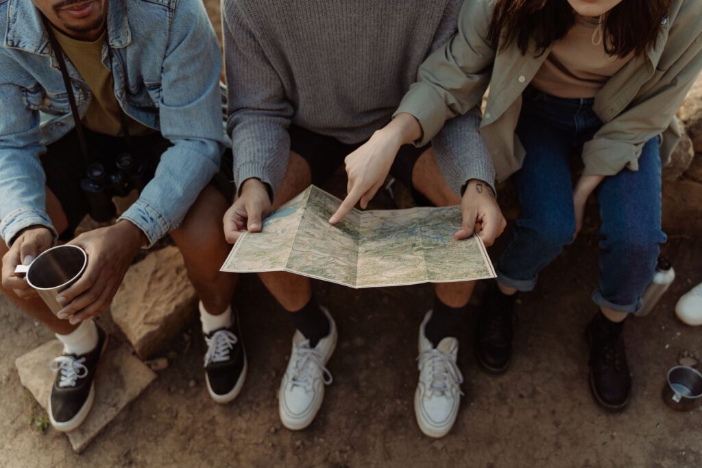 A group of friends planning their golf trip over a map. — golf trip Dungeness