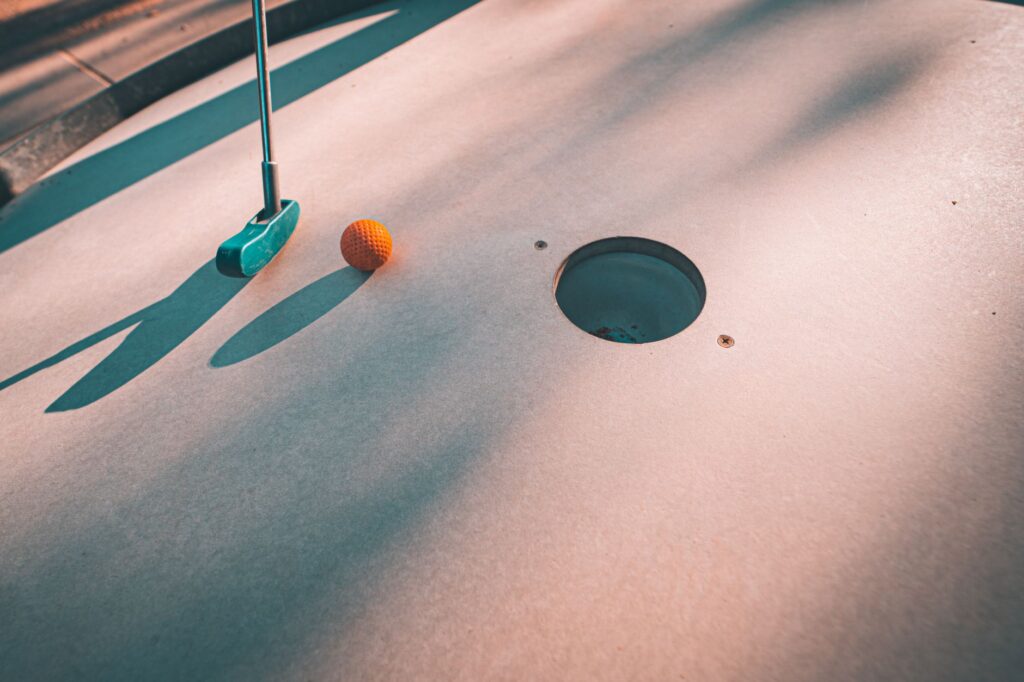 A joyful family playing mini-golf in Dungeness, showcasing fun and engagement. — family golf Dungeness