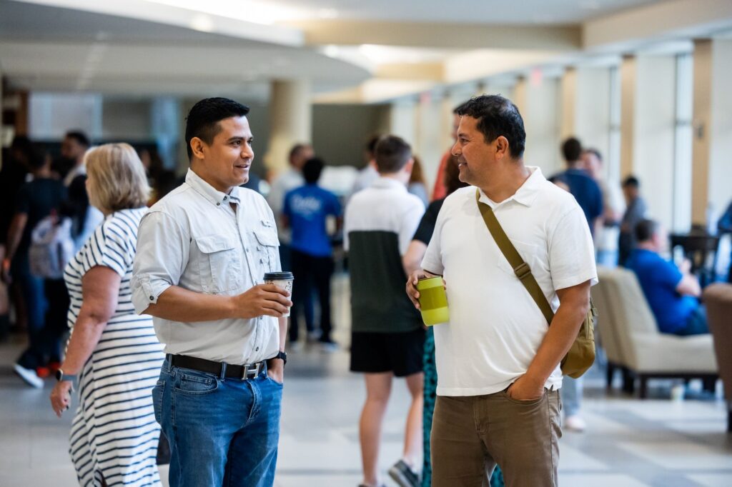 Golfers networking at a Dungeness event, exchanging contacts. — Dungeness golf events fall 2026